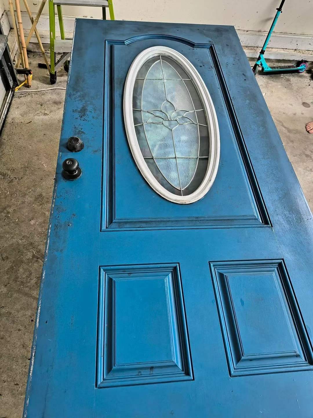 Close-up of the repainted front door surface after coating.